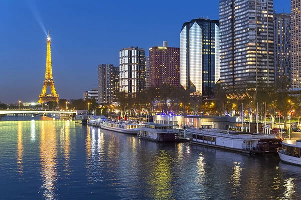 Night view of River Seine with high-rise buildings on the Left Bank, and Eiffel Tower