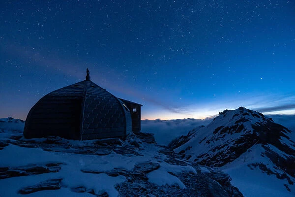 Nightscape of Igloo refuge des Pantalons Blancs in Swiss Alps mountains