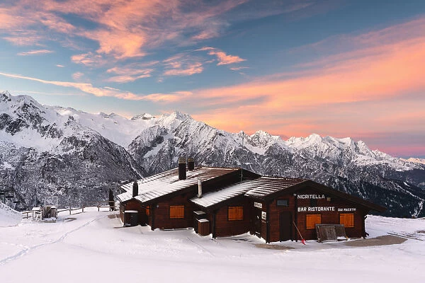 Nigritella refuge in Winter season at dawn, Stelvio national park in Camonica valley