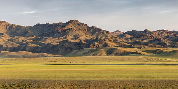 Nomadic camp with livestock and mountains in the background. Bayandalai district