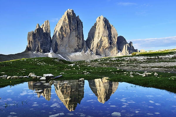 North walls of the Three Peaks reflected in a large puddle, Sexten Dolomites, Alta