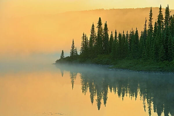 Northern lake in fog at sunrise Chibougameau, Quebec, Canada