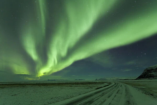 Northern Lights, Aurora Borealis, Winter road with snow, Iceland