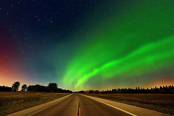 Northern lights or aurora borealis and road Birds Hill Provincial Park, Manitoba, Canada