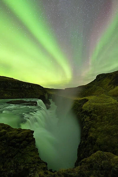 the Northern Lights over iconic Gullfoss waterfall during an autumn night, Iceland