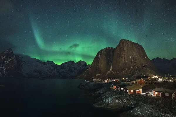 Northern lights in the sky over the village. Hamnoy, Nordland county, Northern Norway