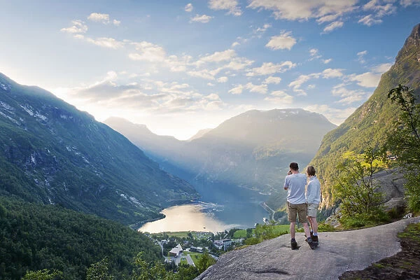 Norway, Western Fjords, Geiranger Fjord, Couple standing on rock infront of Fjord