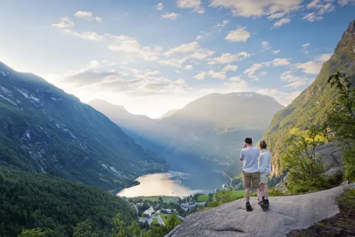 Framed Print : Norway, Western Fjords, Geiranger Fjord, Couple standing on rock infront of Fjord Framed Print : Norway, Western Fjords, Geiranger Fjord, Couple standing on rock infront of Fjord