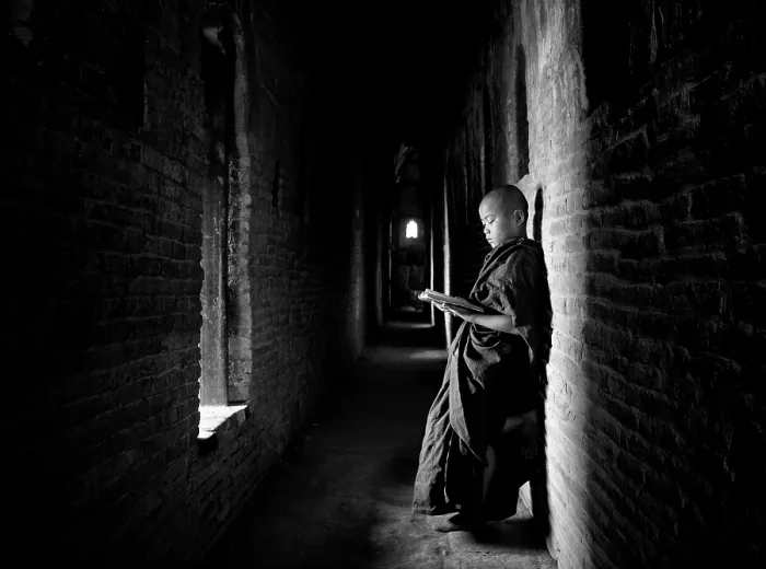 Framed Print : Novice Buddhist monk reading Buddhist scriptures in the light of a window in one of the many temples of Bagan, Myanmar (Burma) Framed Print : Novice Buddhist monk reading Buddhist scriptures in the light of a window in one of the many temples of Bagan, Myanmar (Burma)