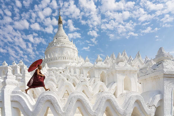 Novice monk running and jumping at Hsinbyume pagoda, Mingun, Mandalay, Sagaing Township