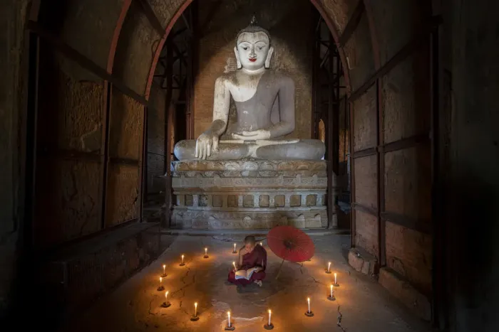 Framed Print : Novice monk studying inside a temple under big Buddha statue, UNESCO, Bagan Framed Print : Novice monk studying inside a temple under big Buddha statue, UNESCO, Bagan