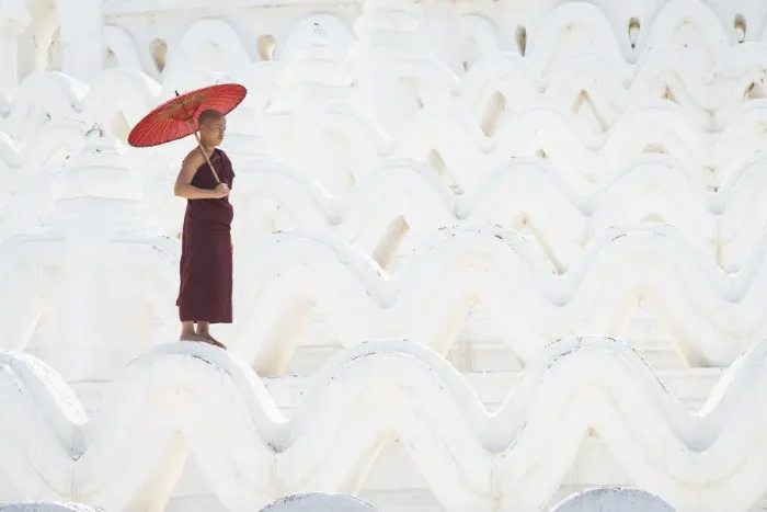 Framed Print : Novice monk with an umbrella standing at white Hsinbyume pagoda Framed Print : Novice monk with an umbrella standing at white Hsinbyume pagoda