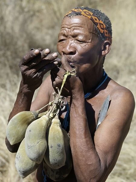 A N!!S hunter-gatherer lights his pipe to relax having