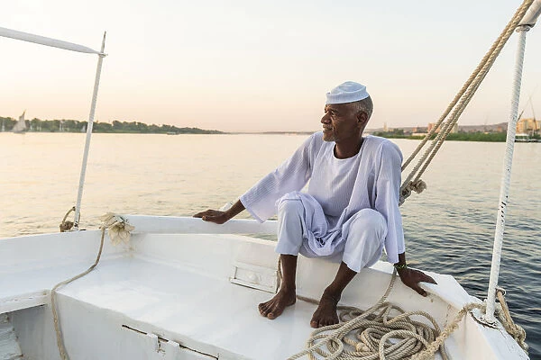 Nubian sailor on his felucca boat on the Nile River, Aswan, Upper Egypt, Egypt, Africa