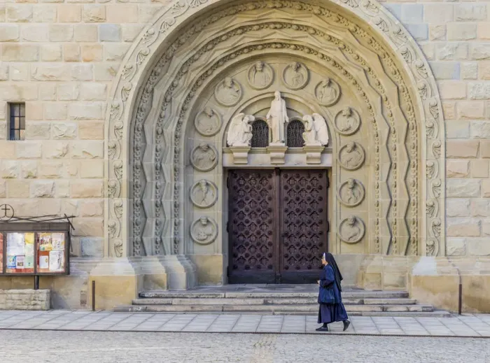 Framed Print : A nun walking past the Cathedral of St. Nicholas in Bielsko Biala, Silesian Voivodeship Framed Print : A nun walking past the Cathedral of St. Nicholas in Bielsko Biala, Silesian Voivodeship