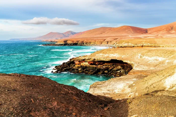 Framed Print : Ocean waves crashing on Playa De Garcey beach surrounded by volcanic cliffs, Fuerteventura, Canary Islands, Spain Framed Print : Ocean waves crashing on Playa De Garcey beach surrounded by volcanic cliffs, Fuerteventura, Canary Islands, Spain