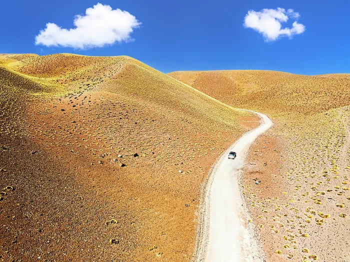 Framed Print : Off-road vehicle among colorful slopes, Vega de los Colorados, Puna, Catamarca, Argentina