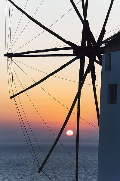 Oia village, Santorini, Cyclades Islands, Greece. Sunset through the windmill landmark