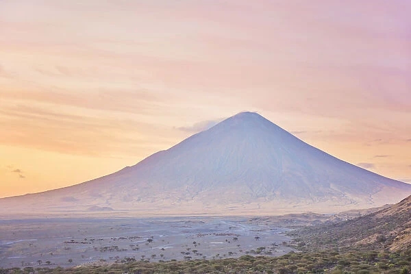 The 'Ol Doinyo Lengai'volcano at sunrise, Arusha Region, Tanzania. An active volcano in the Gregory Rift, south of Lake Natron, considered by the Msai people as 'The Mountain of God'