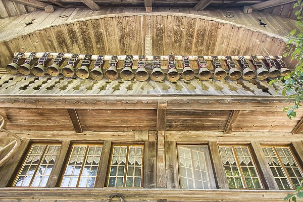 Old chalet with display of cow bells, in the Emmental Valley, Berner Oberland, Switzerland
