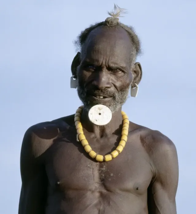Framed Print : An old Dassanech man wearing a traditional lip ornament and earrings