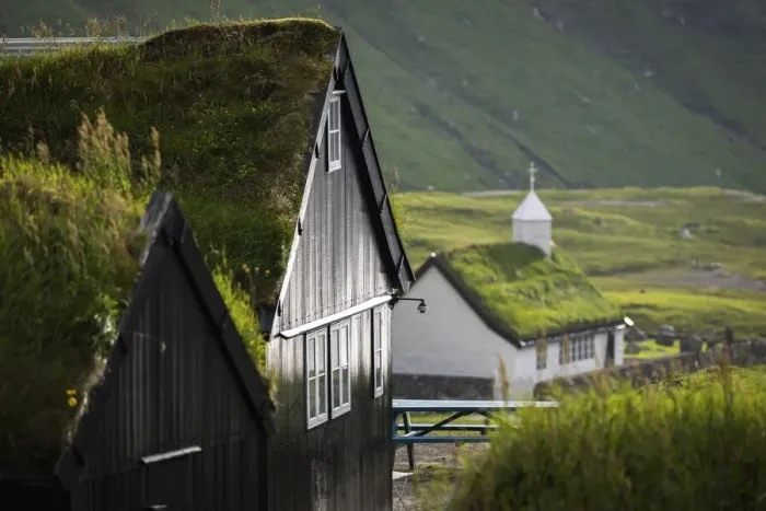Framed Print : The old Duvugarðar farm and the church of Saksun. Stryemoy, Faroe Islands