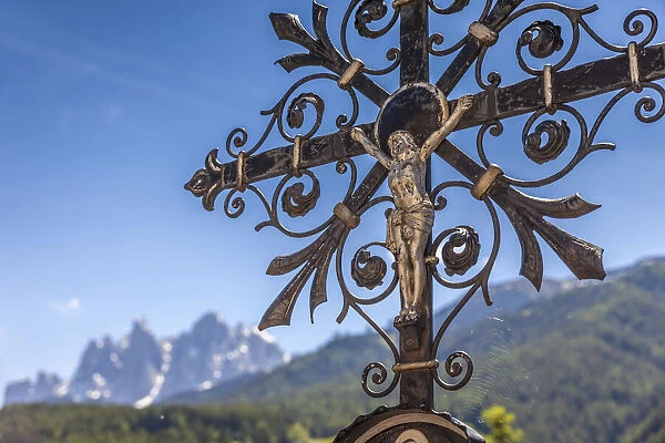 Old grave cross in the cemetery of St. Peter in Villnoess Valley, South Tyrol, Italy