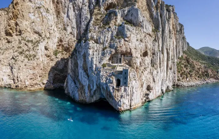 Framed Print : Old mining area in the rock above the turquoise sea in Sardinia, Italy. Porto Flavia