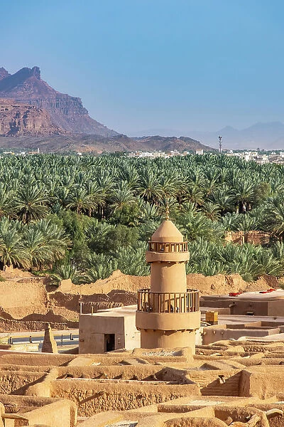 Old mosque minaret, Date palms and old town ruins in the Oasis of Al-Ula, Medina Province, Saudi Arabia