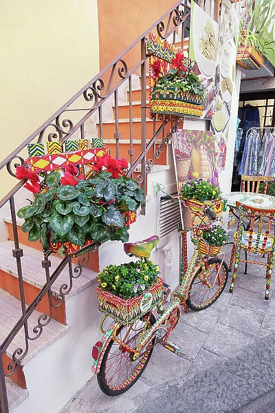 Old town alley filled with artwork and decorations, Taormina, Sicily, Italy