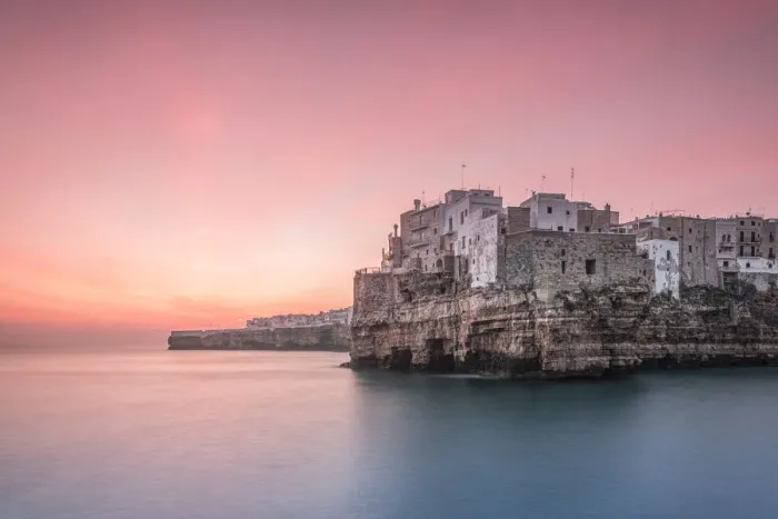 Framed Print : Old town of Polignano a Mare built on rocky cliffs at sunrise, Bari province, Apulia