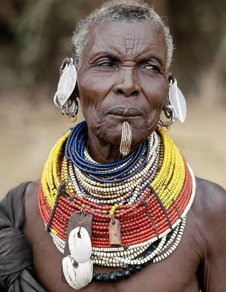 An old Turkana woman wearing all the finery of her tribe