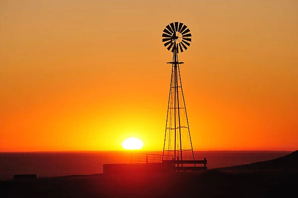 Old west windmill at sunset, Pawnee National Grassland, Colorado, USA