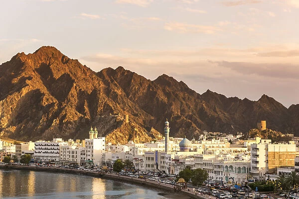 Oman, Muscat. Cityscape of Mutrah old town, elevated view, at sunset