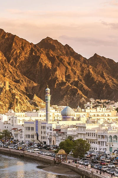 Oman, Muscat. Cityscape of Mutrah old town, elevated view, at sunset