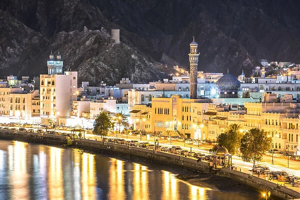 Oman, Muscat. Cityscape of Mutrah old town, elevated view, at dusk