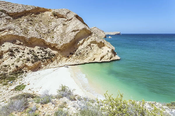 Oman, Muscat, Qantab. Rocky coastline and deserted beach, near Muscat
