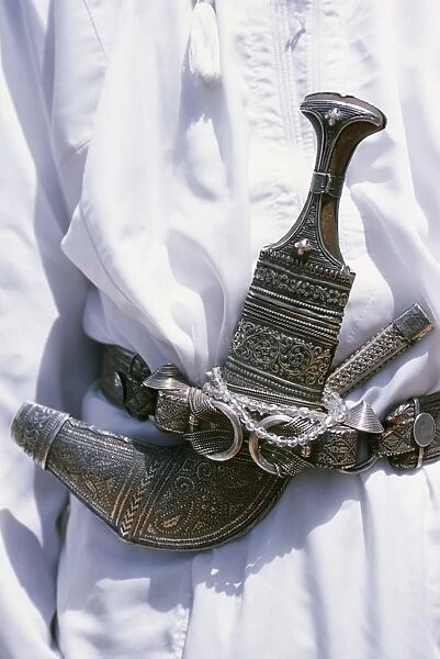 Omani men wear the traditional long white robes and