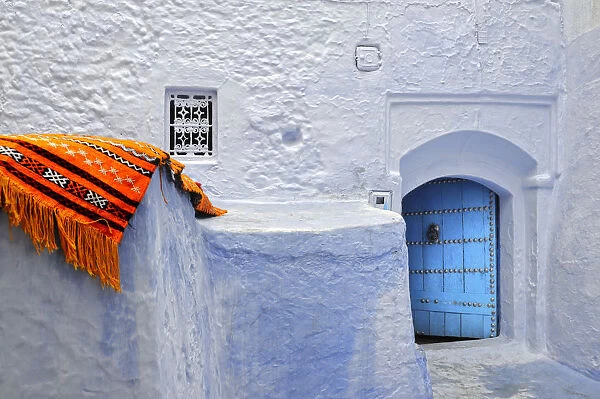 Orange blanket in the bluish Chefchaouen medina. Morocco