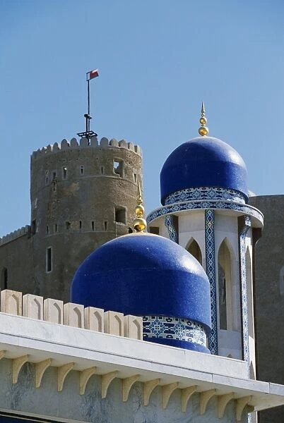 The ornate domes and minaret of the Khor Mosque contrast