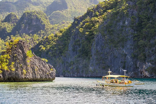 Outrigger boat anchored at Twin Peaks Reef off the coast of Coron Island, Coron, Palawan