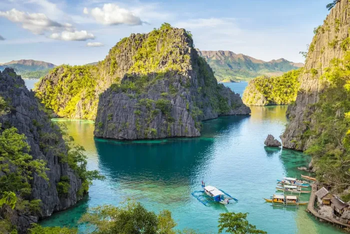 Framed Print : Outrigger boats and small village in a rocky inlet on Coron Island, Coron, Palawan Framed Print : Outrigger boats and small village in a rocky inlet on Coron Island, Coron, Palawan