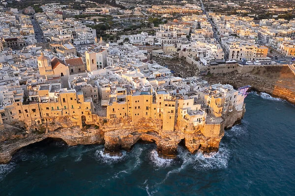 Overhanging houses of Polignano a Mare at sunrise. Bari district, Apulia, Italy