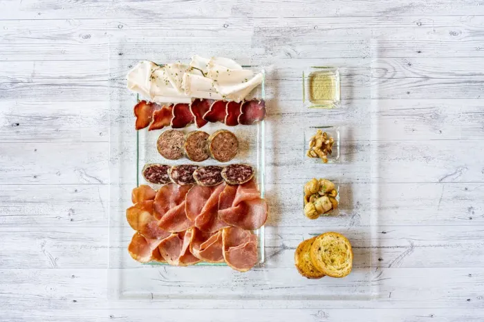 Framed Print : Overhead view of mixed cold cuts in glass serving plate with croutons as appetizer Framed Print : Overhead view of mixed cold cuts in glass serving plate with croutons as appetizer