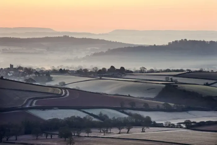 Framed Print : Overlooking frost and mist covered countryside at dawn near the village of Silverton Framed Print : Overlooking frost and mist covered countryside at dawn near the village of Silverton