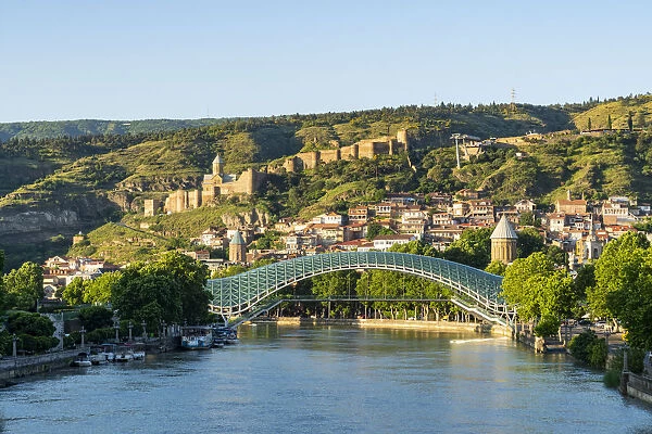 The Pace bridge along Kura river with Narikala castle in the background. Tbilisi, Georgia