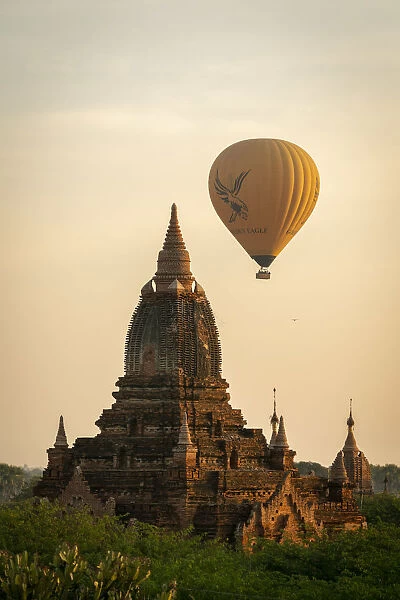Pagoda and hot air balloon at sunrise, Bagan, Myanmar