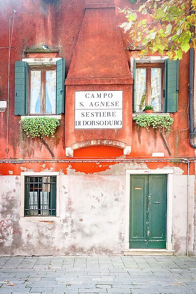 Painted facade of traditional house in an old alley of Venice, Veneto, Italy