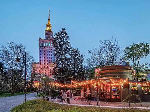 Palace of Culture and Science and Pijana Wisnia Wine Bar at dusk, Warsaw, Masovian Voivodeship, Poland