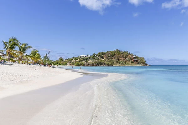 Palm trees and white sand surround the turquoise Caribbean sea Ffryers Beach Antigua